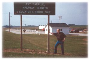 Shintangle is very close the the 45th Parallel, Halfway between the North Pole and the Equator.  Here's Jim at the marker